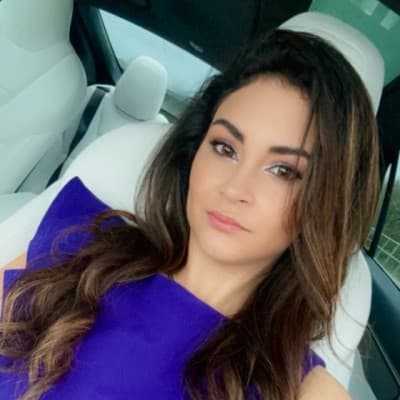 Daliana Pino, real estate agent, smiling in a purple top